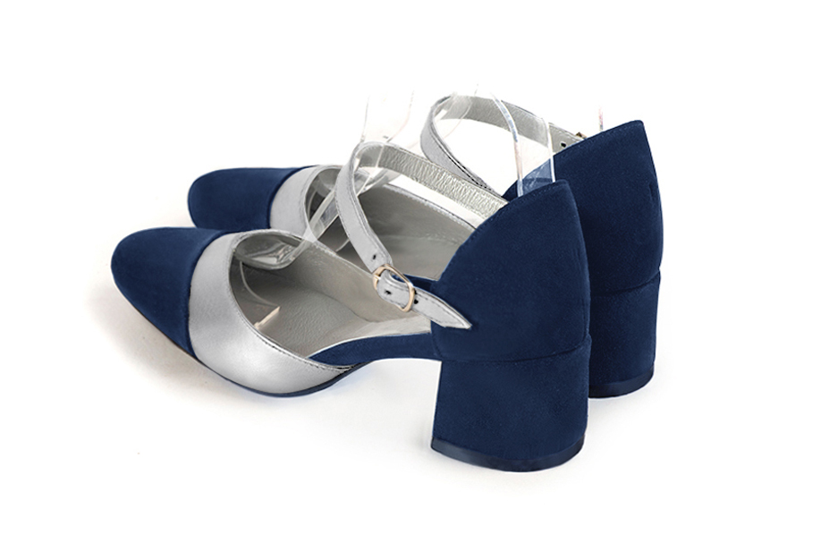 Women's navy blue and silver open side dress shoes, with an instep strap. Round toe. Low flare heels - Rear view